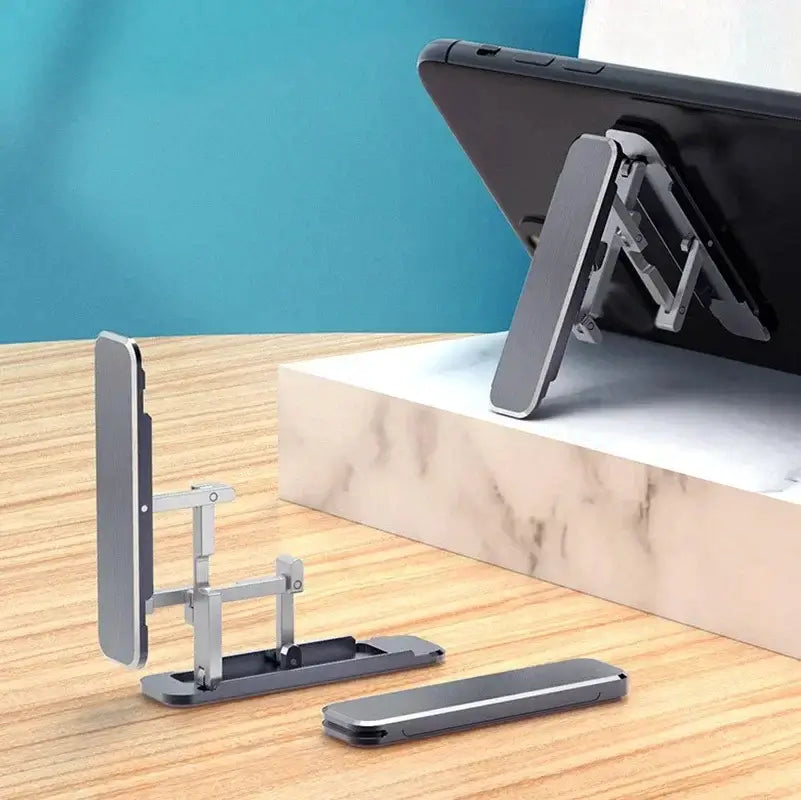 Ultra-slim aluminum folding phone stand in adjustable positions on a desk, showcasing portable design and universal compatibility.